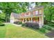 Charming two-story home featuring a welcoming front porch and beautifully landscaped front yard at 210 Malvern Pl, Roswell, GA 30076