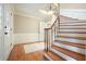 Welcoming foyer showcasing hardwood floors, a staircase, and traditional wainscoting at 210 Malvern Pl, Roswell, GA 30076