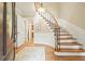 Elegant foyer featuring hardwood floors, a curved staircase, and classic architectural details at 210 Malvern Pl, Roswell, GA 30076