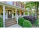 Inviting front porch with a classic design and well-manicured landscaping at 210 Malvern Pl, Roswell, GA 30076