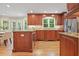 Open kitchen features stainless appliances, a breakfast bar, custom cabinets, granite counters and hardwood floors at 210 Malvern Pl, Roswell, GA 30076