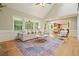 Spacious living room features a vaulted ceiling, hardwood floors, a fireplace, and bright windows at 210 Malvern Pl, Roswell, GA 30076