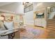 Bright living room features hardwood floors, a cathedral ceiling, and an open layout with a view of the staircase at 210 Malvern Pl, Roswell, GA 30076