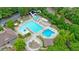 Aerial view of a community pool area with water slides, lounge chairs, and surrounding trees at 210 Malvern Pl, Roswell, GA 30076