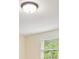 Bright room featuring a window and a modern light fixture on the ceiling at 210 Malvern Pl, Roswell, GA 30076