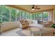 Screened porch has wooded views, ceiling fan, and wicker furniture at 210 Malvern Pl, Roswell, GA 30076