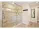 Luxurious shower with glass enclosure, tiled walls, and a built-in bench at 210 Malvern Pl, Roswell, GA 30076