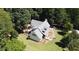 Stunning aerial view of a charming home on a sprawling 15-acre lot with lush landscaping and mature trees at 4392 Lower Fayetteville Rd, Sharpsburg, GA 30277
