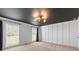 Bright bedroom featuring black ceiling, large windows, and carpet floors at 4392 Lower Fayetteville Rd, Sharpsburg, GA 30277