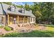 Charming home featuring a stone walkway leading to a covered front porch with wooden columns and shuttered windows at 4392 Lower Fayetteville Rd, Sharpsburg, GA 30277