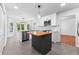 Bright kitchen features an island, stainless steel appliances, and white cabinets at 4392 Lower Fayetteville Rd, Sharpsburg, GA 30277