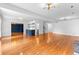 Open-concept living room with hardwood floors, fireplace, and stylish blue accent bar at 4392 Lower Fayetteville Rd, Sharpsburg, GA 30277