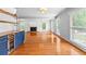Large living room with hardwood floors, a fireplace, and a built-in bar area at 4392 Lower Fayetteville Rd, Sharpsburg, GA 30277