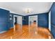 Living room with hardwood floors, wainscoting, and modern lighting fixtures at 4392 Lower Fayetteville Rd, Sharpsburg, GA 30277