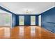 Living room with hardwood floors, wainscoting, and plenty of natural light at 4392 Lower Fayetteville Rd, Sharpsburg, GA 30277