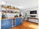 Entertaining area featuring custom bar with wood countertop and cabinetry; open floor plan to formal living area at 4392 Lower Fayetteville Rd, Sharpsburg, GA 30277