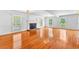 Bright living room with a fireplace, hardwood flooring and windows offering ample natural light at 4392 Lower Fayetteville Rd, Sharpsburg, GA 30277