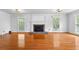 Spacious living room featuring a fireplace and hardwood flooring with abundant natural light at 4392 Lower Fayetteville Rd, Sharpsburg, GA 30277