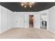 Large primary bedroom features ensuite bathroom, black ceiling, updated lighting, and neutral carpet at 4392 Lower Fayetteville Rd, Sharpsburg, GA 30277