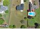 Aerial view highlights a vast, fenced backyard, patio space, complemented by neighboring greenery and community pool at 502 Owens Springs Ln, Mcdonough, GA 30252