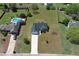 Aerial view of the property showcases a spacious lot, long driveway, and proximity to neighboring homes and community pool at 502 Owens Springs Ln, Mcdonough, GA 30252