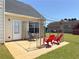 Backyard patio featuring a metal framed canopy with seating and a well-maintained lawn at 502 Owens Springs Ln, Mcdonough, GA 30252