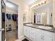 Bright bathroom with double sinks, a large mirror, and access to a well-organized walk-in closet at 502 Owens Springs Ln, Mcdonough, GA 30252