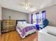 Bright bedroom with hardwood floors, a ceiling fan, and a window with sheer curtains at 502 Owens Springs Ln, Mcdonough, GA 30252