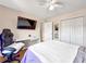 Bright bedroom featuring a ceiling fan, desk, and closet with double doors at 502 Owens Springs Ln, Mcdonough, GA 30252