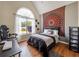 Bedroom with a vaulted ceiling, a large arched window, and unique wall decor at 502 Owens Springs Ln, Mcdonough, GA 30252