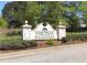 Entrance to Virginia Meadows shows a well-maintained sign surrounded by lush landscaping and mature trees at 502 Owens Springs Ln, Mcdonough, GA 30252