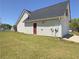 Exterior shot of a house with a clean yard, showing the side door and garage at 502 Owens Springs Ln, Mcdonough, GA 30252