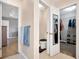 Hallway view showcasing access to a bathroom with toilet, walk-in closet, and another bedroom with hardwood floors at 502 Owens Springs Ln, Mcdonough, GA 30252