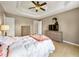 Cozy main bedroom featuring a trey ceiling, ceiling fan, hardwood floors, ample closet space, and natural light at 502 Owens Springs Ln, Mcdonough, GA 30252