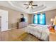 Large main bedroom featuring a trey ceiling, king-size bed, hardwood floors, ample closet space, and a large window at 502 Owens Springs Ln, Mcdonough, GA 30252