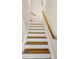 Staircase with wooden handrail offers a classic design at 502 Owens Springs Ln, Mcdonough, GA 30252