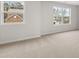 A bright bedroom with neutral carpet and a view of new construction houses at 7164 Linden Dr, South Fulton, GA 30349