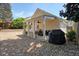 Home's charming backyard features a covered patio and landscaped space with river rock at 123 Stoneforest Dr, Woodstock, GA 30189