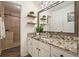 Bathroom featuring granite countertop, framed mirror, and tiled shower at 123 Stoneforest Dr, Woodstock, GA 30189