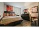 Comfortable bedroom with a dark wood bed frame, matching dresser, and soft lighting at 123 Stoneforest Dr, Woodstock, GA 30189
