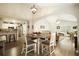 Open-concept dining area leads to a kitchen and living room with vaulted ceilings and hardwood floors at 123 Stoneforest Dr, Woodstock, GA 30189