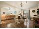 Bright dining area with a decorative hanging light and hardwood floors adjacent to the living room at 123 Stoneforest Dr, Woodstock, GA 30189