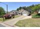 Attractive brick home featuring a tidy front yard, an attached garage, and long driveway at 123 Stoneforest Dr, Woodstock, GA 30189