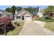 Inviting single-story brick house with an attached garage and a driveway at 123 Stoneforest Dr, Woodstock, GA 30189