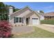 Charming one-story brick home featuring a well-manicured lawn and an attached garage at 123 Stoneforest Dr, Woodstock, GA 30189