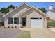 Charming single-story brick home boasts a well-manicured front yard and an attached one-car garage at 123 Stoneforest Dr, Woodstock, GA 30189