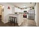 Well-lit kitchen featuring white cabinets, stainless steel appliances, a granite counter, and bar stool seating at 123 Stoneforest Dr, Woodstock, GA 30189