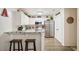 Bright kitchen with white cabinets, granite counters, and stainless steel appliances, plus bar stool seating at 123 Stoneforest Dr, Woodstock, GA 30189