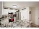 Kitchen with white cabinets, granite counters, and stainless steel appliances, plus decor on top of the cabinets at 123 Stoneforest Dr, Woodstock, GA 30189