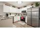 Kitchen with white cabinets, stainless steel appliances and granite counters, providing a functional and modern design at 123 Stoneforest Dr, Woodstock, GA 30189